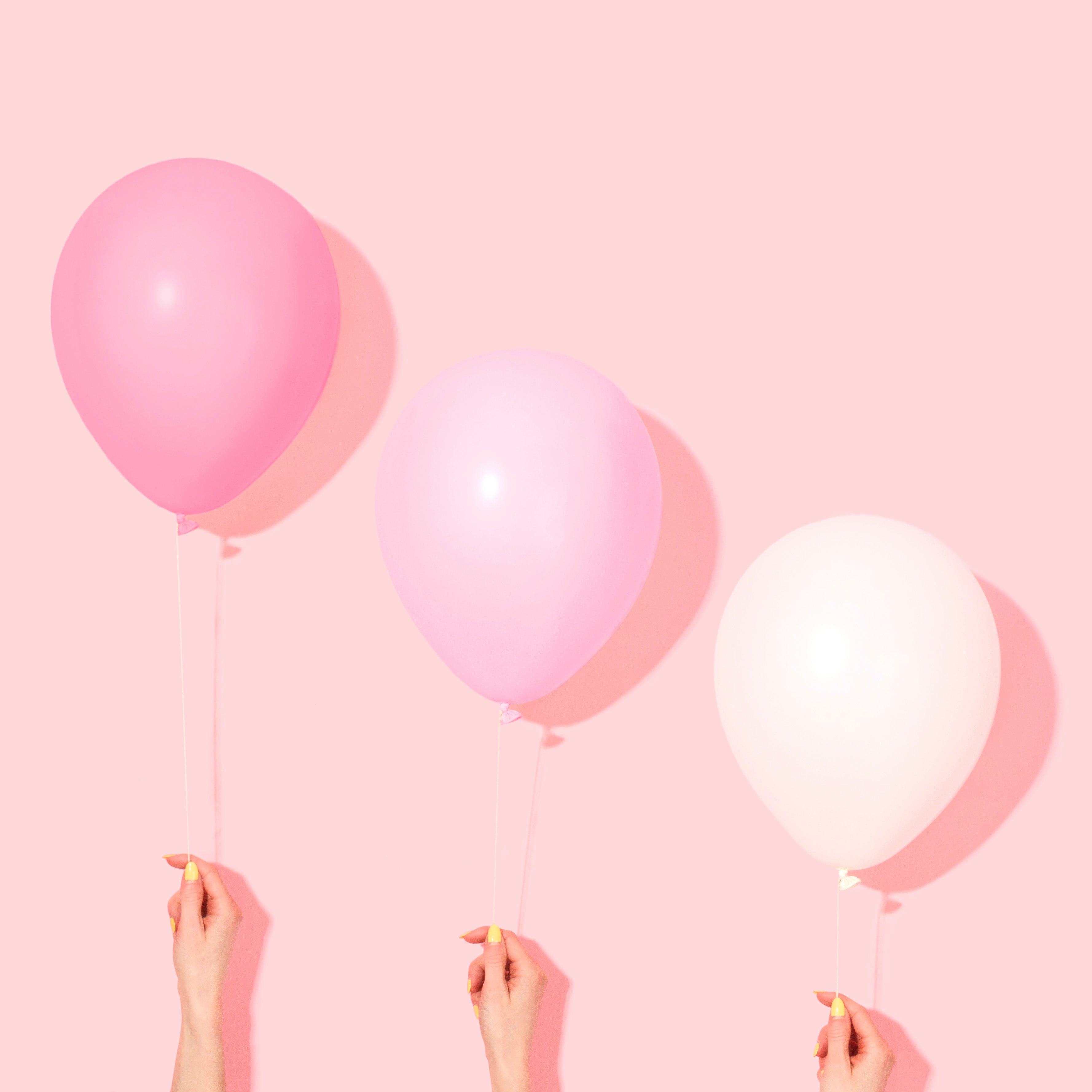 A pink balloon that says party hanging from a string photo – Free
