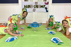 Children at dinosaur themed party with decorations