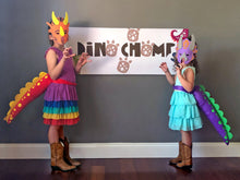Load image into Gallery viewer, Dino chomp banner with kids dressed in dinosaur tails and masks