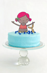 Mermaid cake topper on blue cake