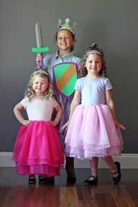 Kids in princess tutus and tiaras and a knight costume