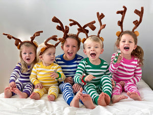 Children in reindeer antlers and striped pajamas