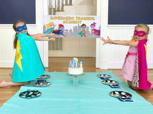 Children at a superhero themed birthday party eating cake