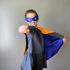 Superhero kid with cape and mask